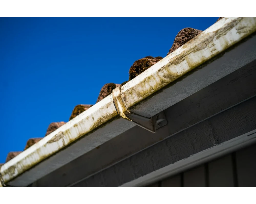 Gutters packed with roof debris before the first storm