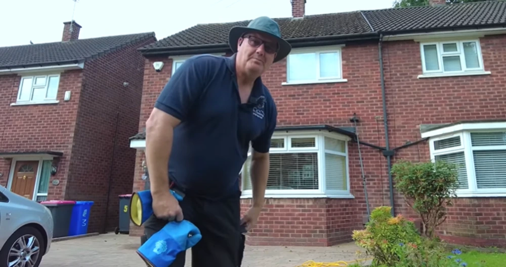 Gutter vacuum cleaning technician