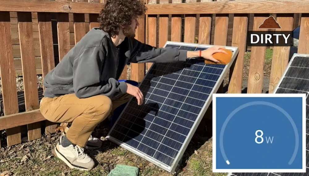 Hand cleaning dirty solar panel