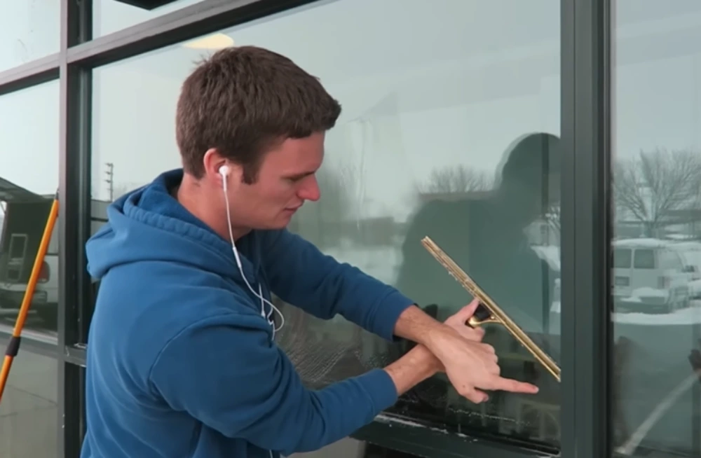 Holding squeegee storefront window tutorial