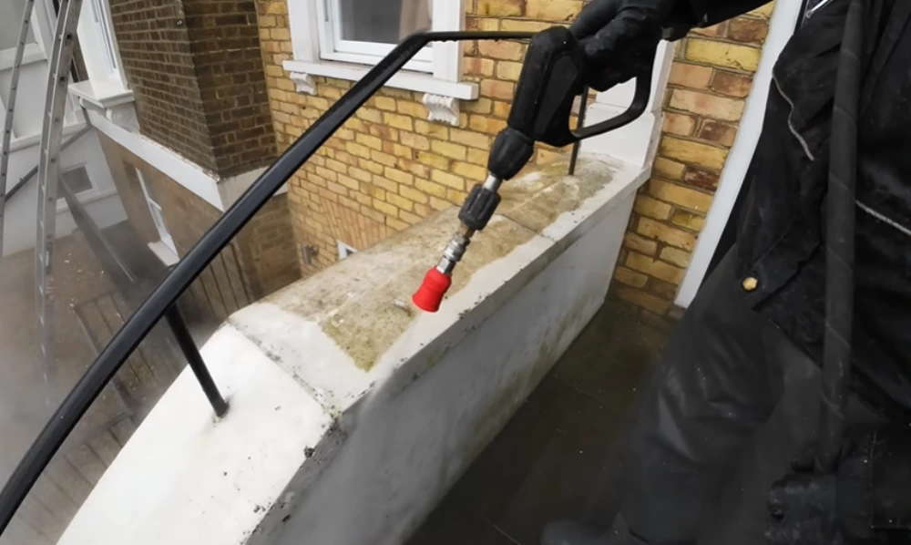 Hot water pressure washing concrete ledge