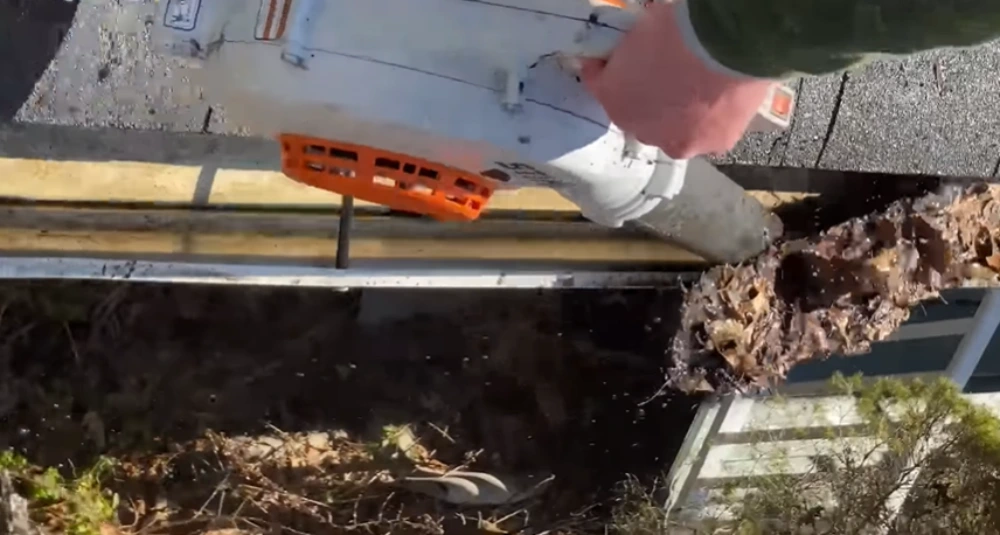Leaf blower gutter debris close-up