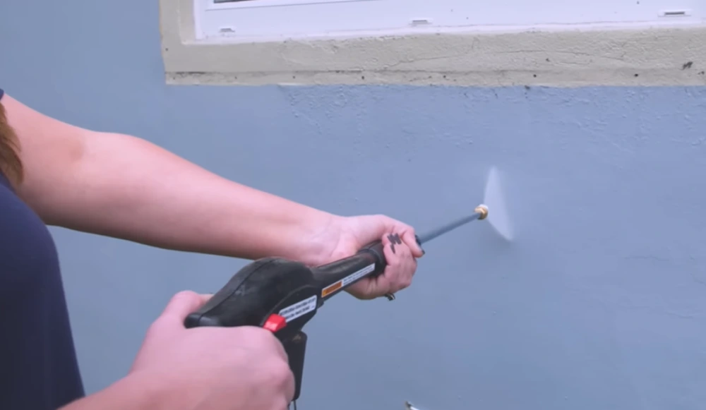 Pressure washer spray on painted wall