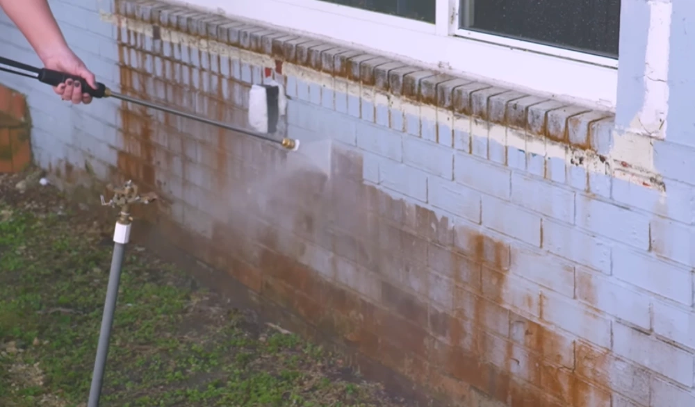 Pressure washing rust stains brick wall