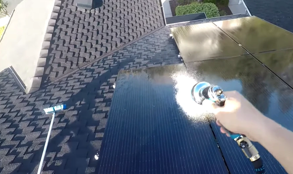 Rinsing solar panels on roof