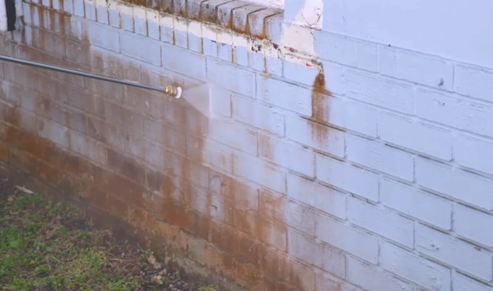 Rust stains on painted brick wall