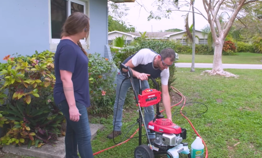 Setting up a gas pressure washer before deck and patio cleaning by our window cleaning Santa Cruz crew