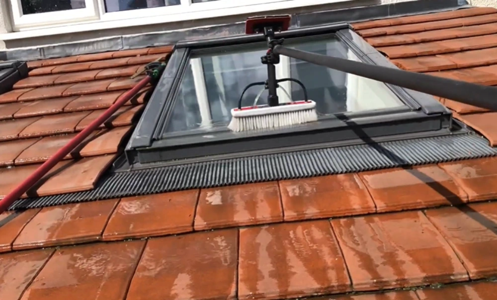 Brushing a skylight on a tile roof