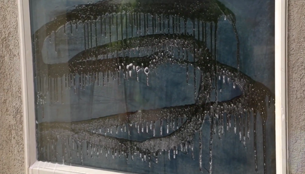 Soapy window glass with drips