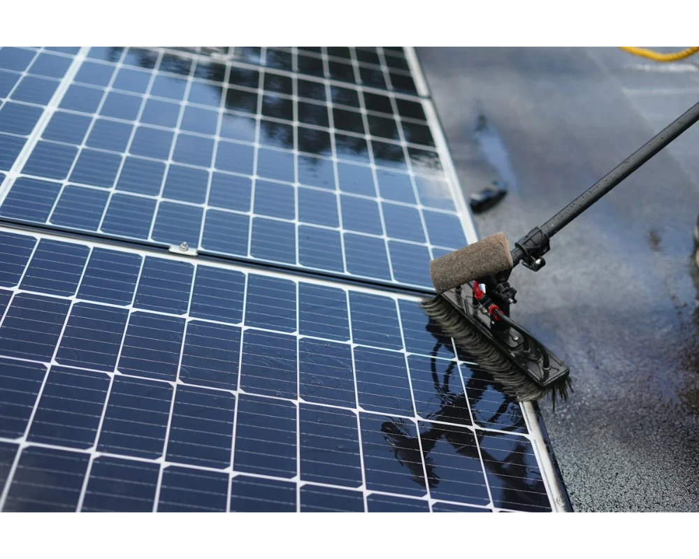 Solar panel being cleaned with a soft brush and pure water
