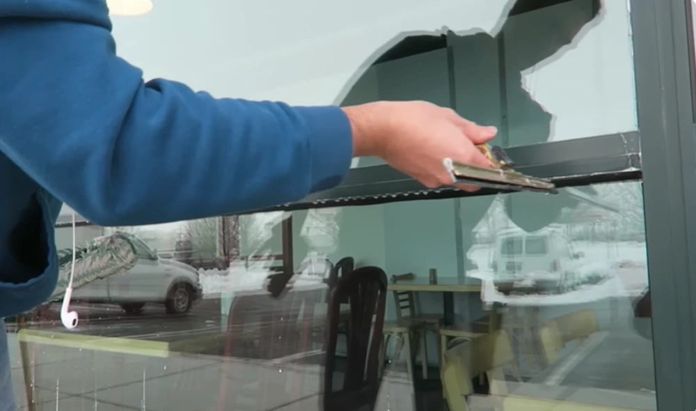 Squeegee edge pull storefront window