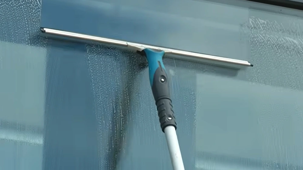 Squeegee on extension pole glass close-up