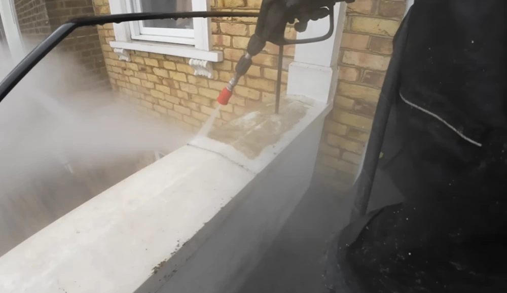 Steam cleaning concrete wall ledge