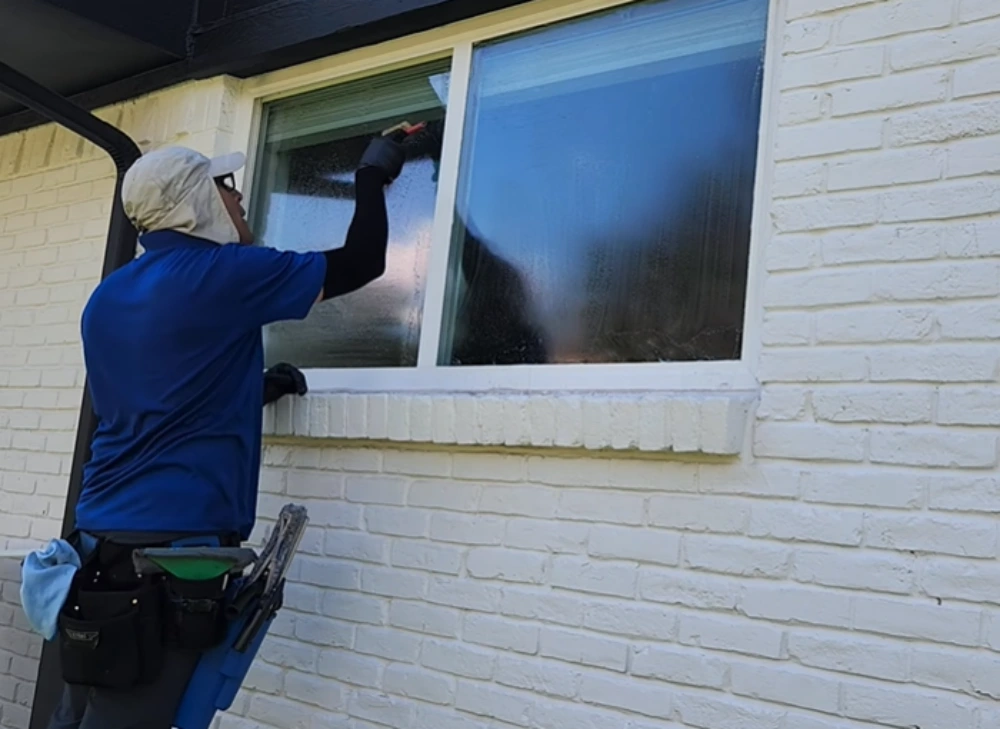 Window cleaning Santa Cruz: washing exterior window brick house