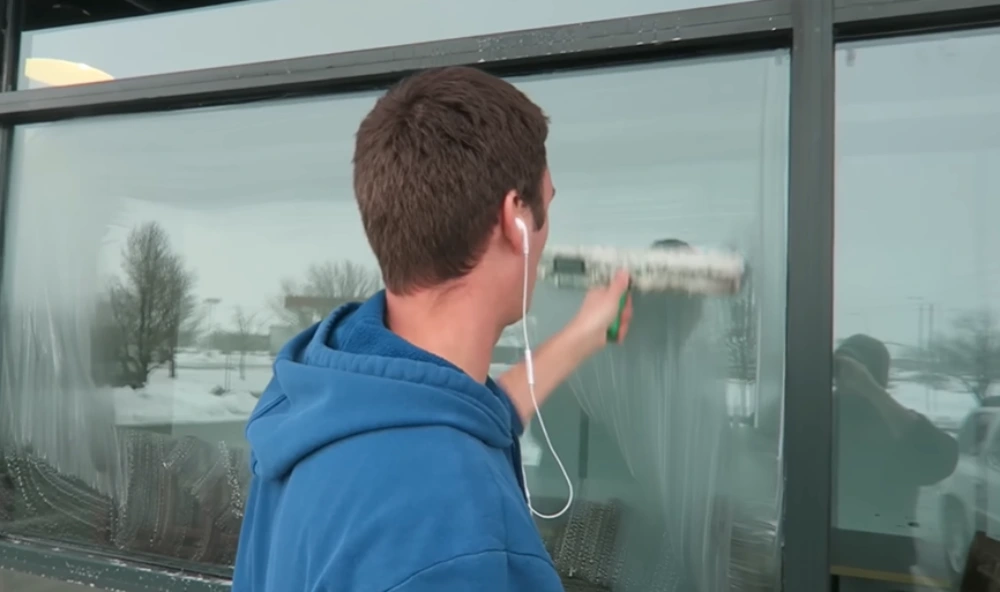 Washing soapy storefront window