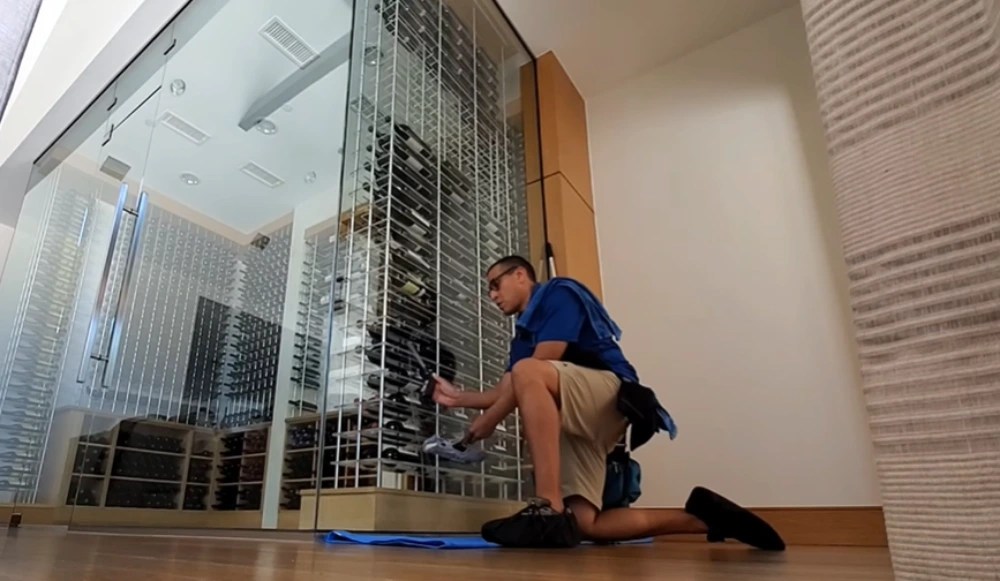 Window cleaning Santa Cruz: wiping glass panel edge kneeling
